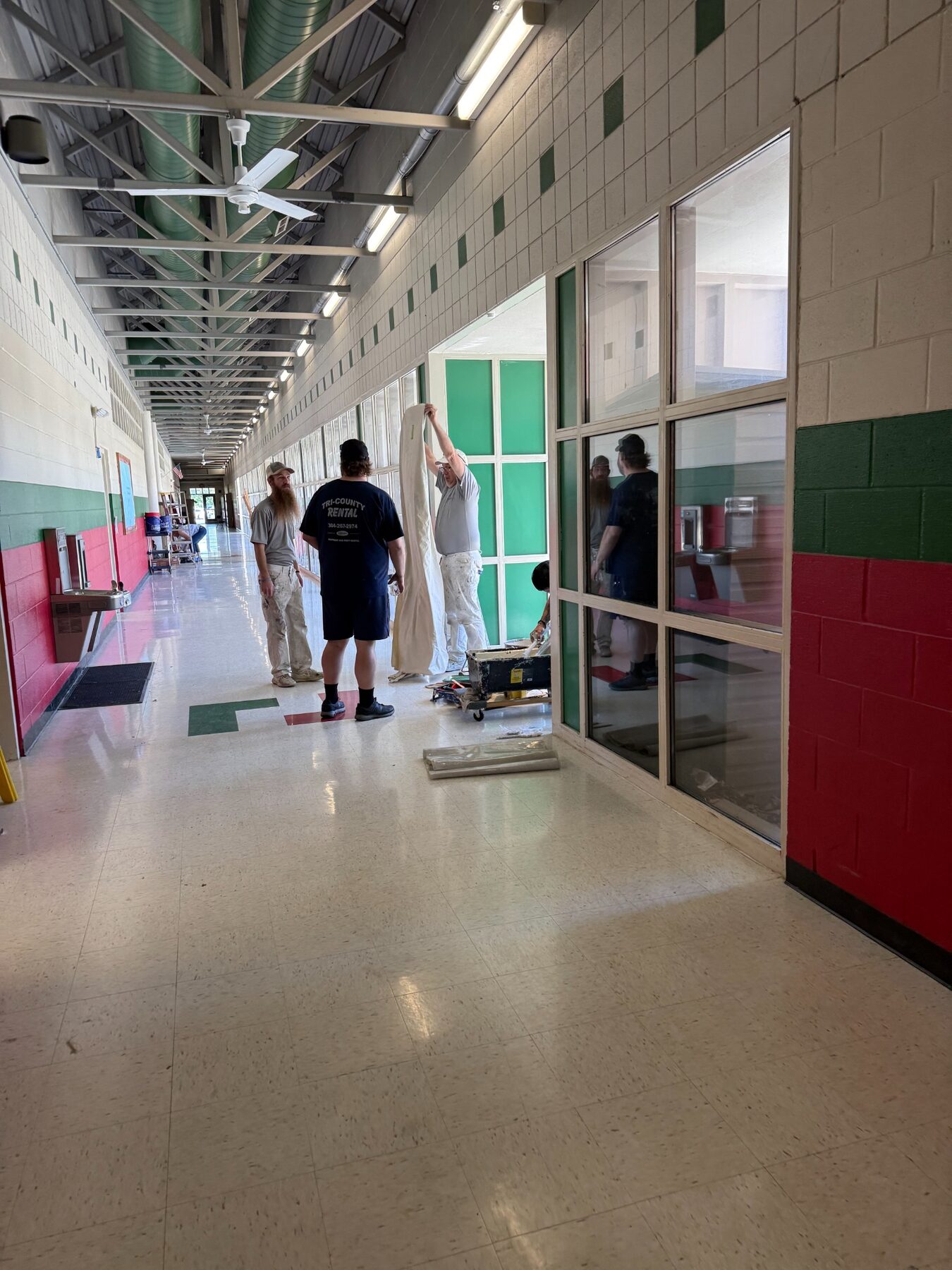 Volunteers working together in a local school hallway