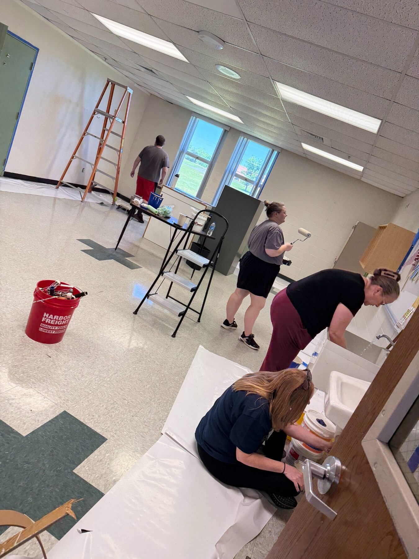 Volunteers painting and refreshing a classroom
