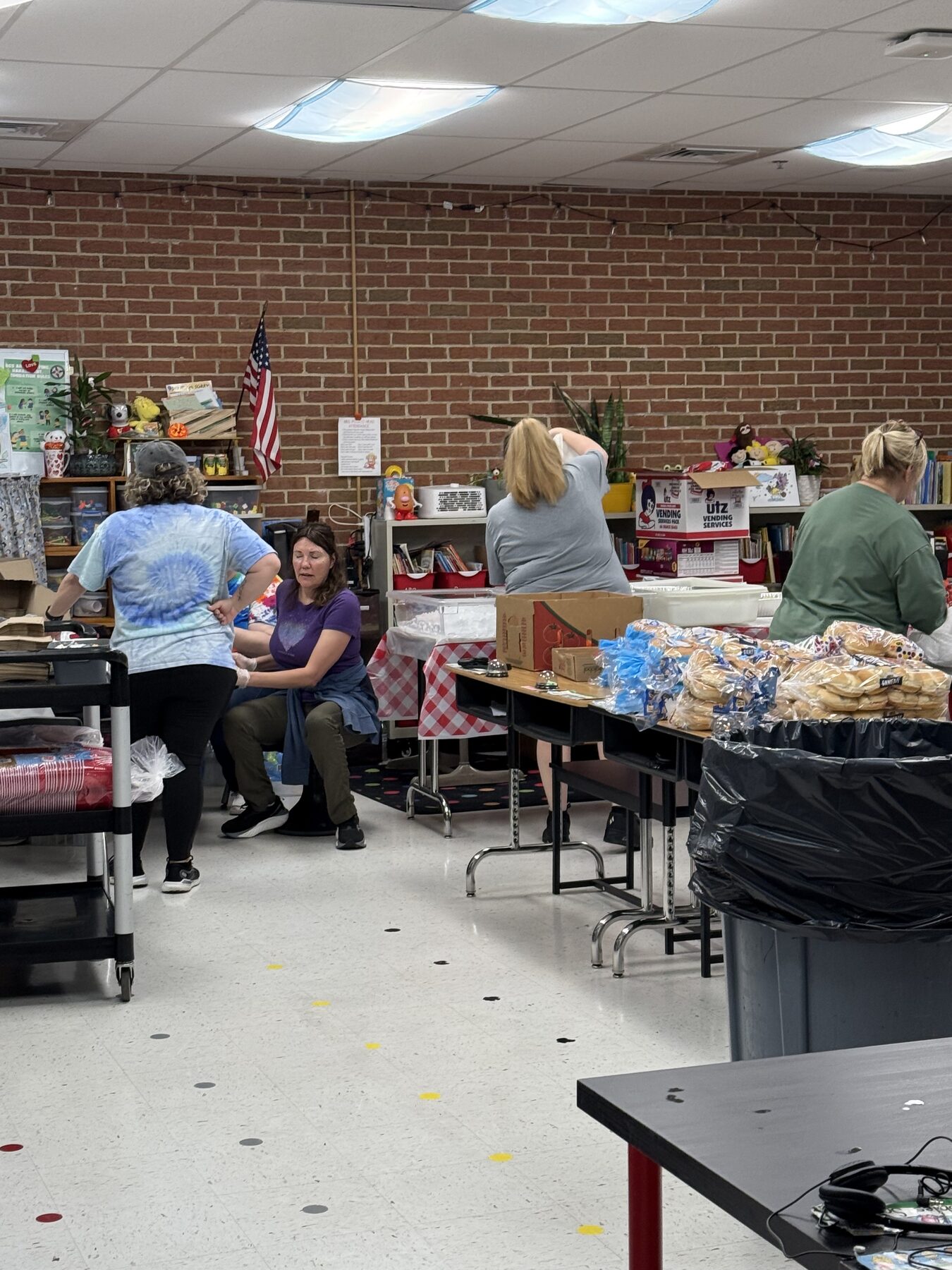 Volunteers organizing supplies at a local elementary school