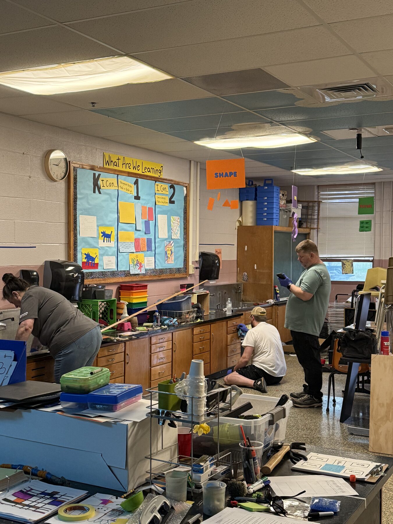 Volunteers cleaning and repairing a classroom at a local elementary school