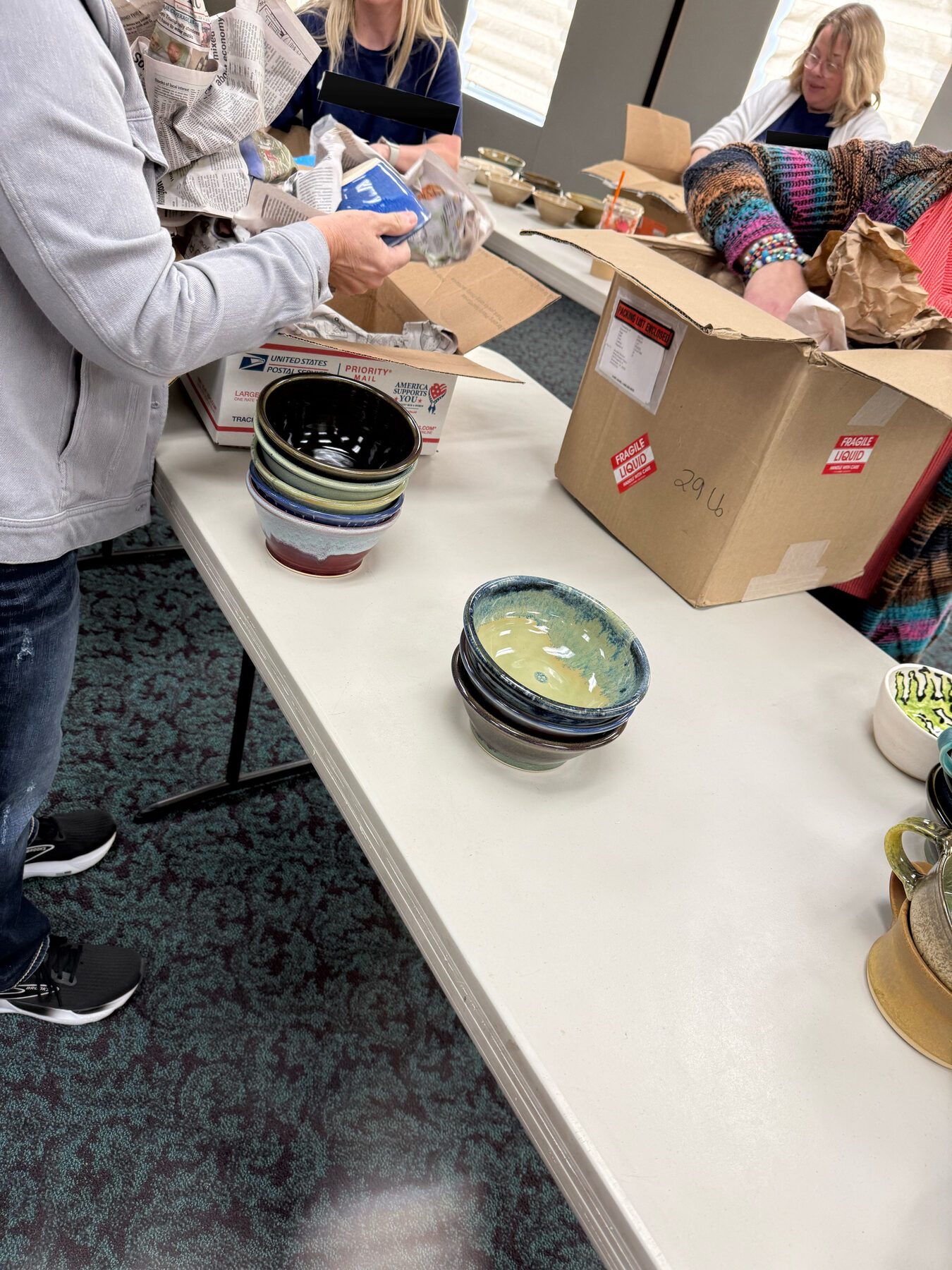 Volunteers preparing handmade bowls for a community ministry